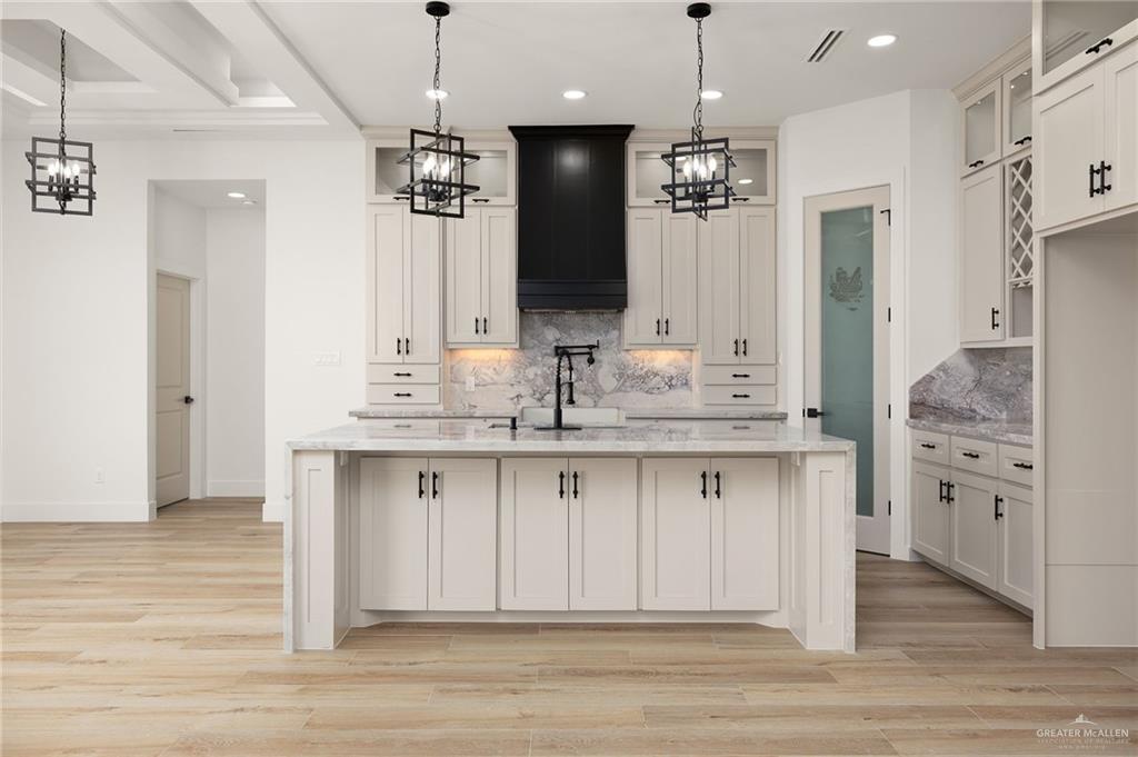 2525 Trinity Avenue McAllen, TX 78504 - Photo 7 of 33 a bathroom with a granite countertop sink a large mirror and a refrigerator