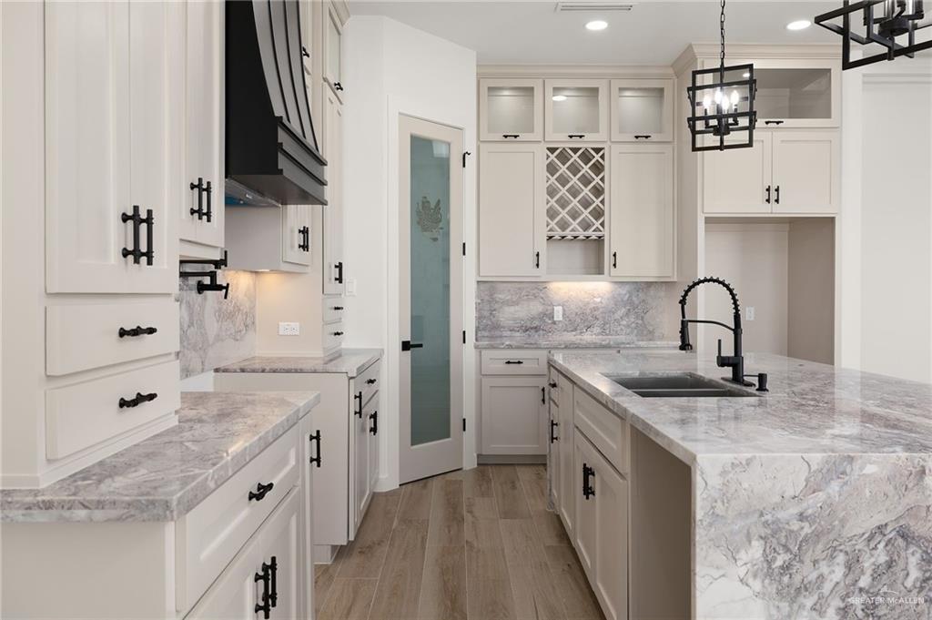 2525 Trinity Avenue McAllen, TX 78504 - Photo 9 of 33 a kitchen with stainless steel appliances granite countertop a sink stove and refrigerator
