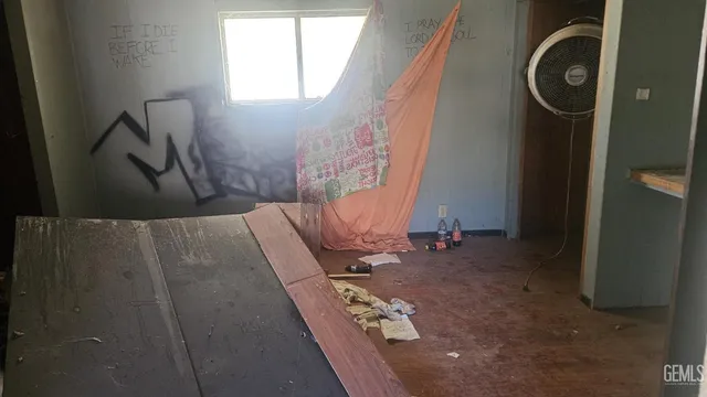 a bathroom with a shower and a wooden floor