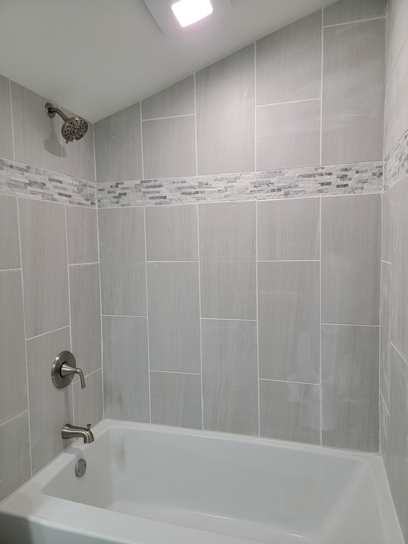 511 North River Road McHenry, IL 60051 - Photo 11 of 22 a bathroom with a shower and a bathtub
