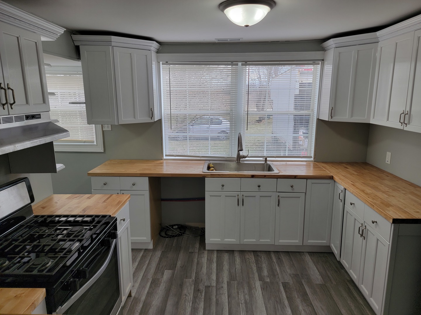 511 North River Road McHenry, IL 60051 - Photo 12 of 22 a kitchen with granite countertop a sink a stove and cabinets