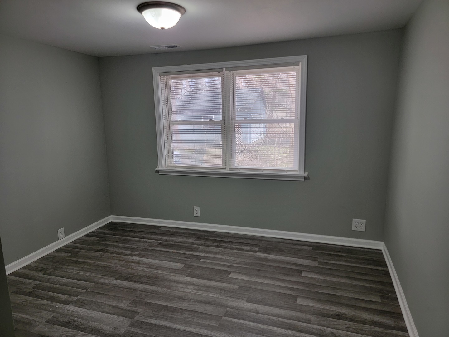 511 North River Road McHenry, IL 60051 - Photo 13 of 22 an empty room with wooden floor and windows