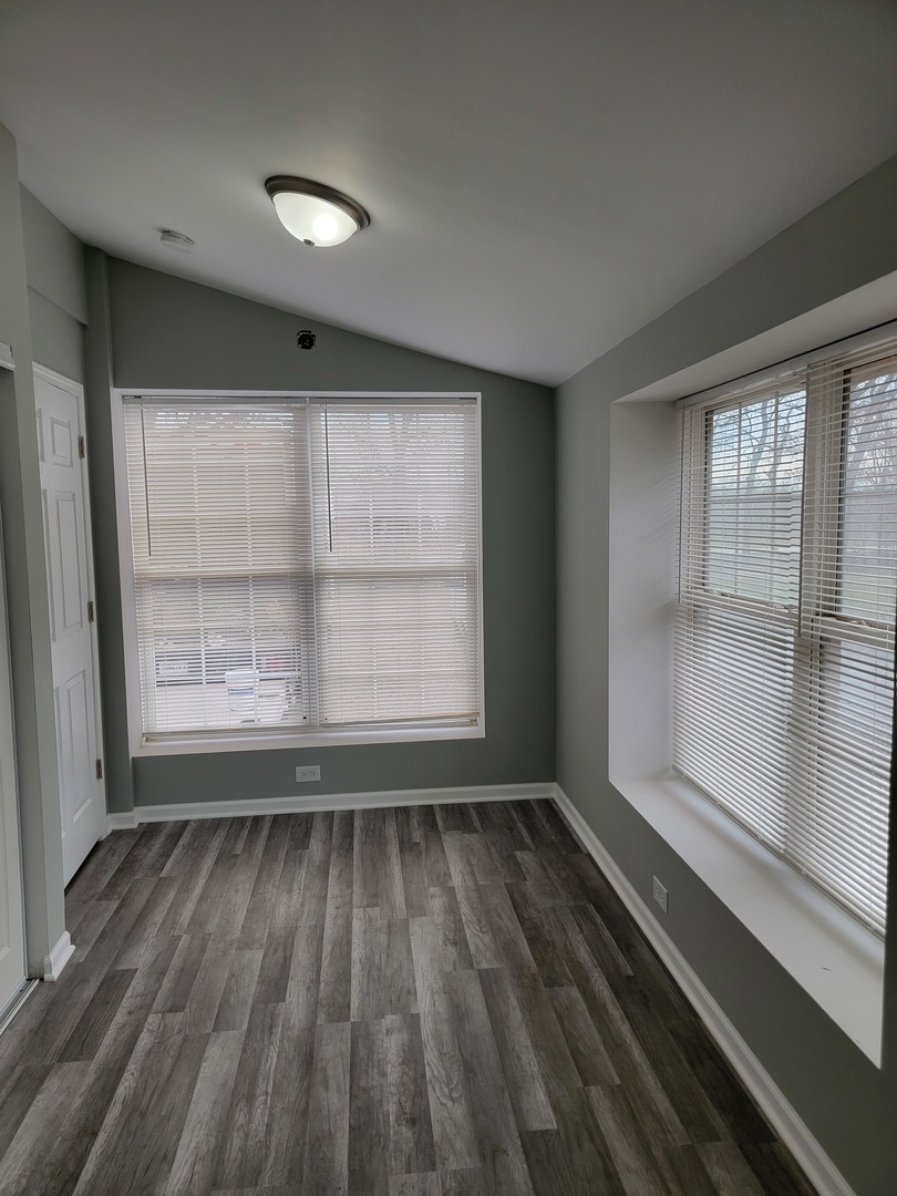 511 North River Road McHenry, IL 60051 - Photo 15 of 22 an empty room with wooden floor and windows