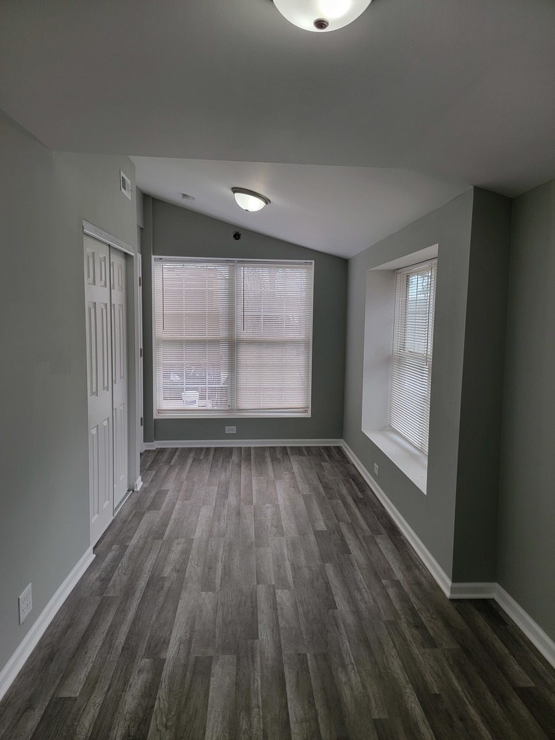 511 North River Road McHenry, IL 60051 - Photo 17 of 22 an empty room with wooden floor and windows