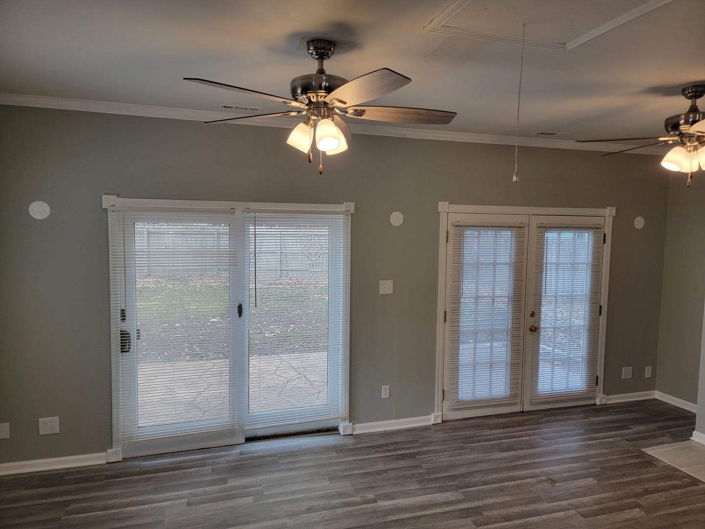 511 North River Road McHenry, IL 60051 - Photo 4 of 22 an empty room with wooden floor fan and windows