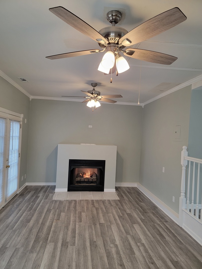 511 North River Road McHenry, IL 60051 - Photo 6 of 22 a view of an empty room with wooden floor fireplace and a window