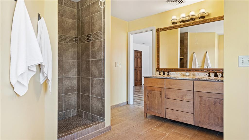 695 North Ben Franklin Road Indiana, PA 15701 - Photo 17 of 25 a bathroom with a double vanity sink a mirror and a shower
