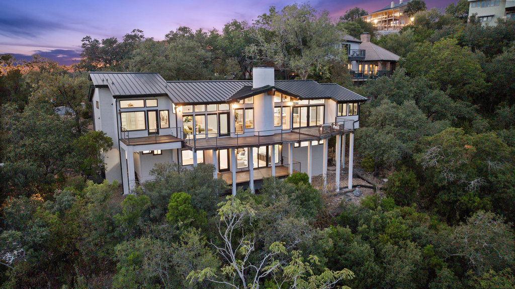 an aerial view of a residential apartment building with a yard and balcony