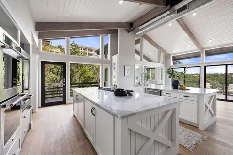 a kitchen with counter top space and wooden floor