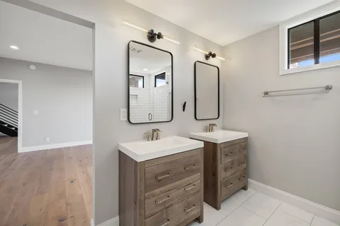 a bathroom with a double vanity sink mirror and