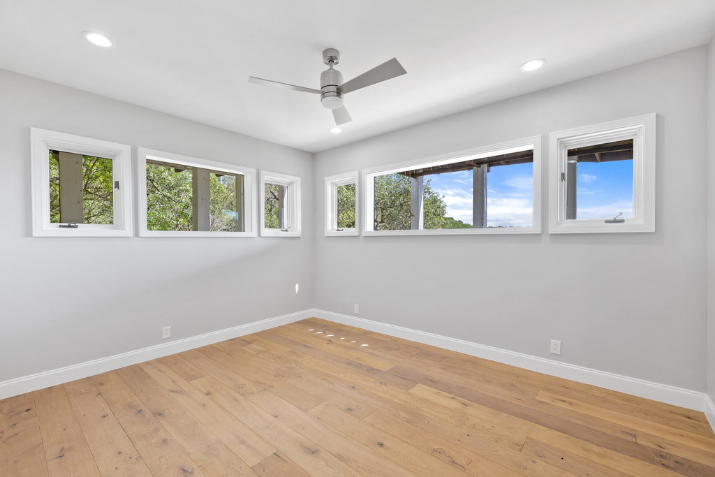 6905 Ladera Norte Austin, TX 78731 - Photo 28 of 40 a view of empty room with wooden floor and fan