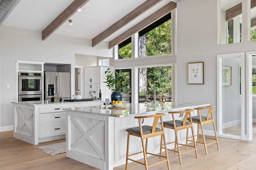6905 Ladera Norte Austin, TX 78731 - Photo 4 of 40 a view of a kitchen with granite countertop a window and white cabinets