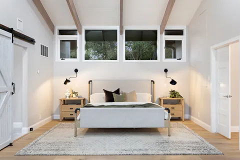 a living room with furniture and large window