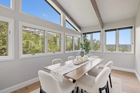 a dining room with furniture a chandelier and wooden floor
