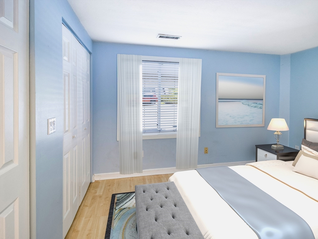 16 Milford Street, Unit 9 Hull, MA 02045 - Photo 18 of 42 a bedroom with a bed and a lamp