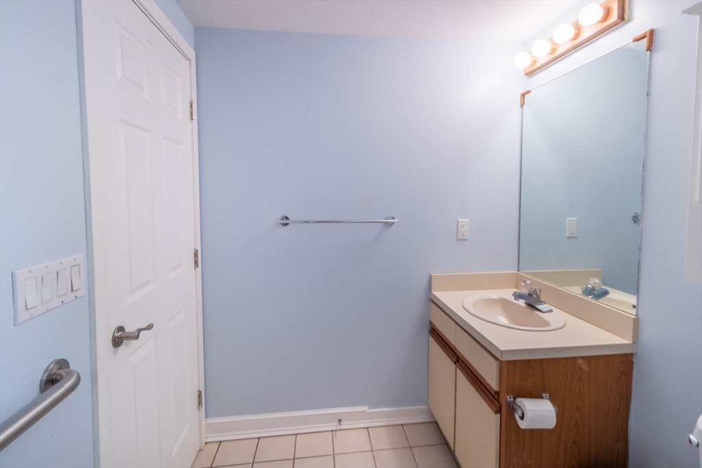 16 Milford Street, Unit 9 Hull, MA 02045 - Photo 22 of 42 a bathroom with a sink and a mirror