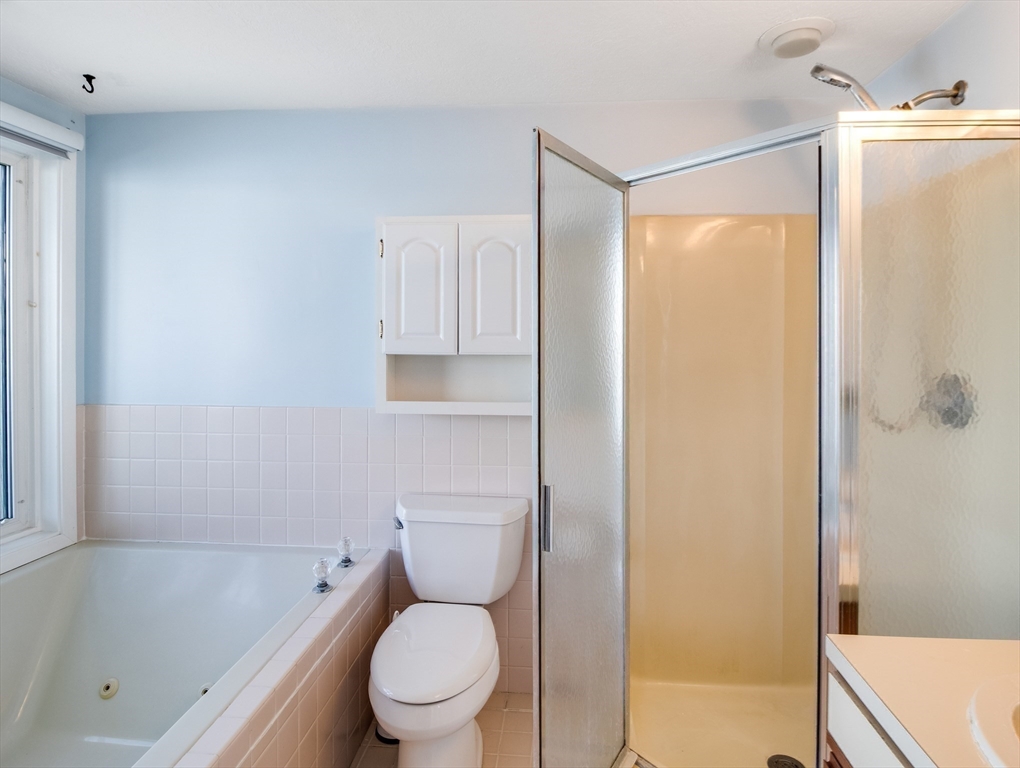 16 Milford Street, Unit 9 Hull, MA 02045 - Photo 30 of 42 a white toilet sitting next to a bath tub