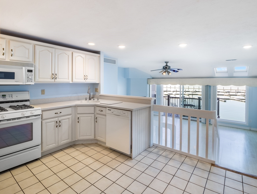 16 Milford Street, Unit 9 Hull, MA 02045 - Photo 10 of 42 a kitchen with a sink window and cabinets