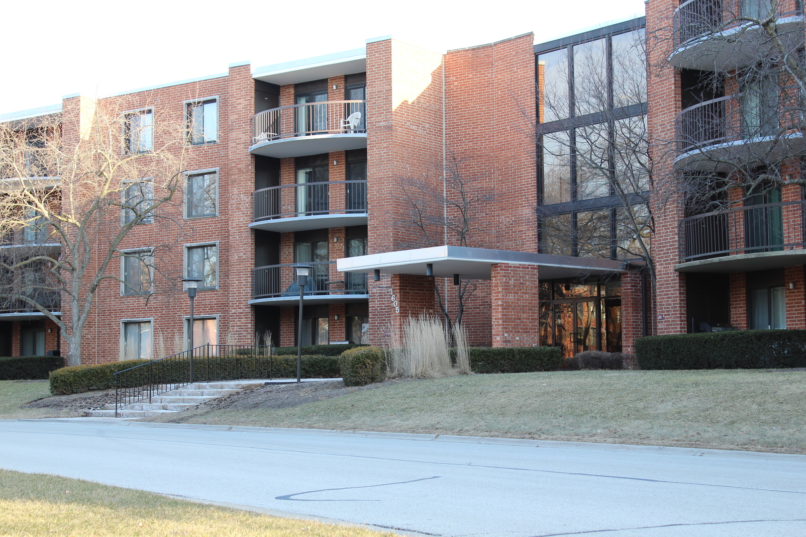 a front view of a residential apartment building with a yard