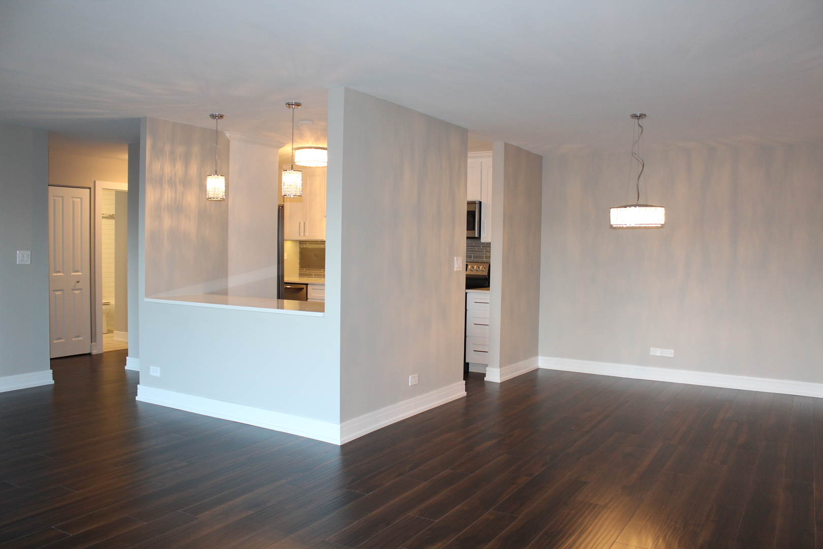 1605 East Central Road, Unit 413B Arlington Heights, IL 60005 - Photo 2 of 15 a view of an empty room with wooden floor and a window
