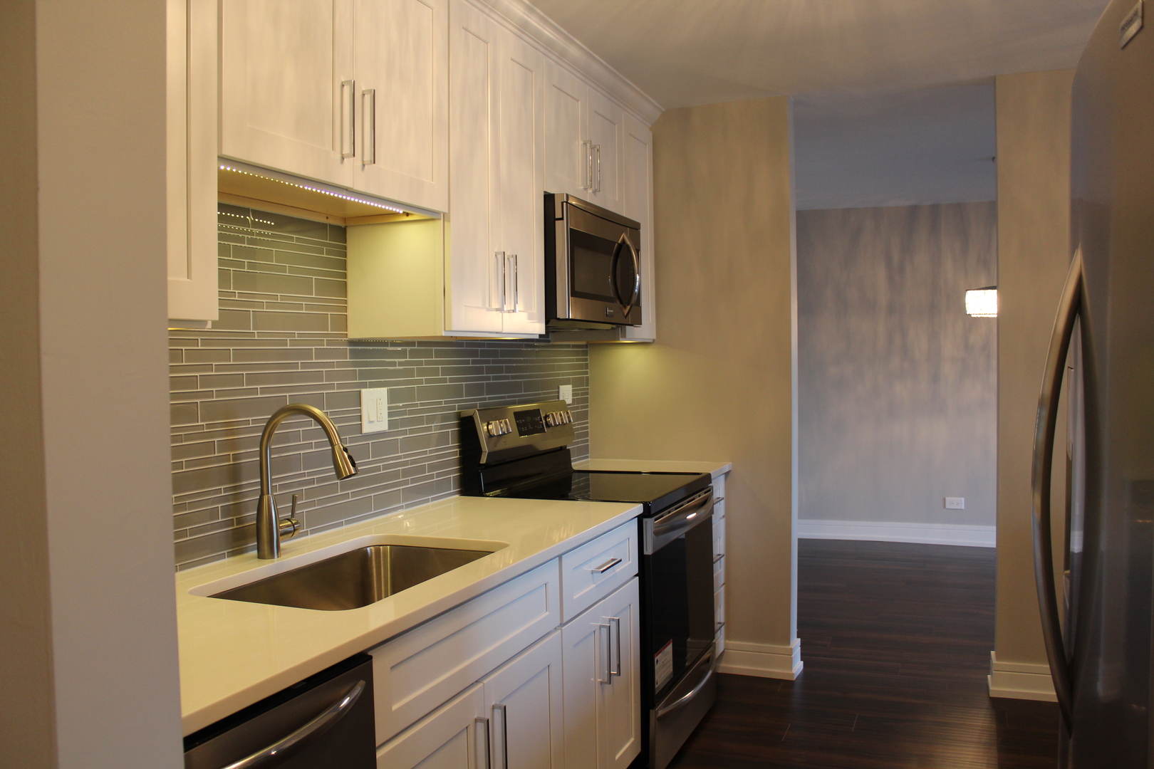 1605 East Central Road, Unit 413B Arlington Heights, IL 60005 - Photo 5 of 15 a kitchen with a sink cabinets and stainless steel appliances