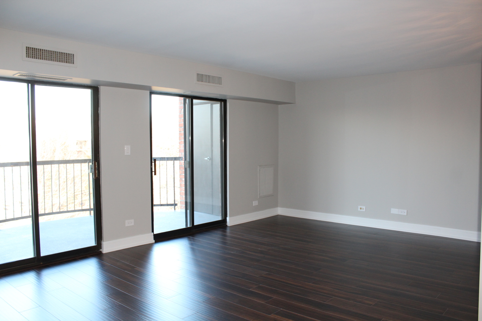 1605 East Central Road, Unit 413B Arlington Heights, IL 60005 - Photo 7 of 15 a view of an empty room with wooden floor and a window