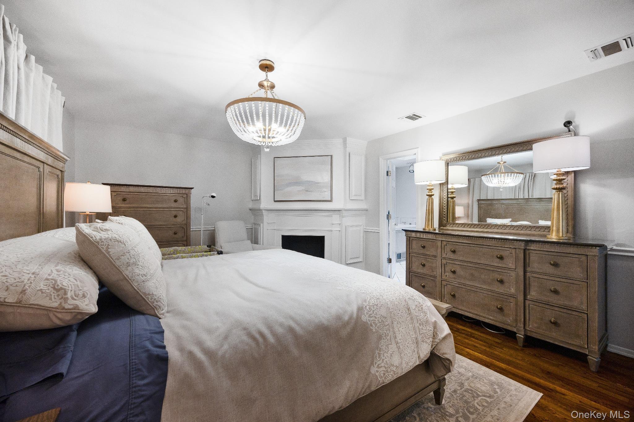 461 Wolf Hill Road Dix Hills, NY 11746 - Photo 19 of 37 a bedroom with a bed and wooden floor