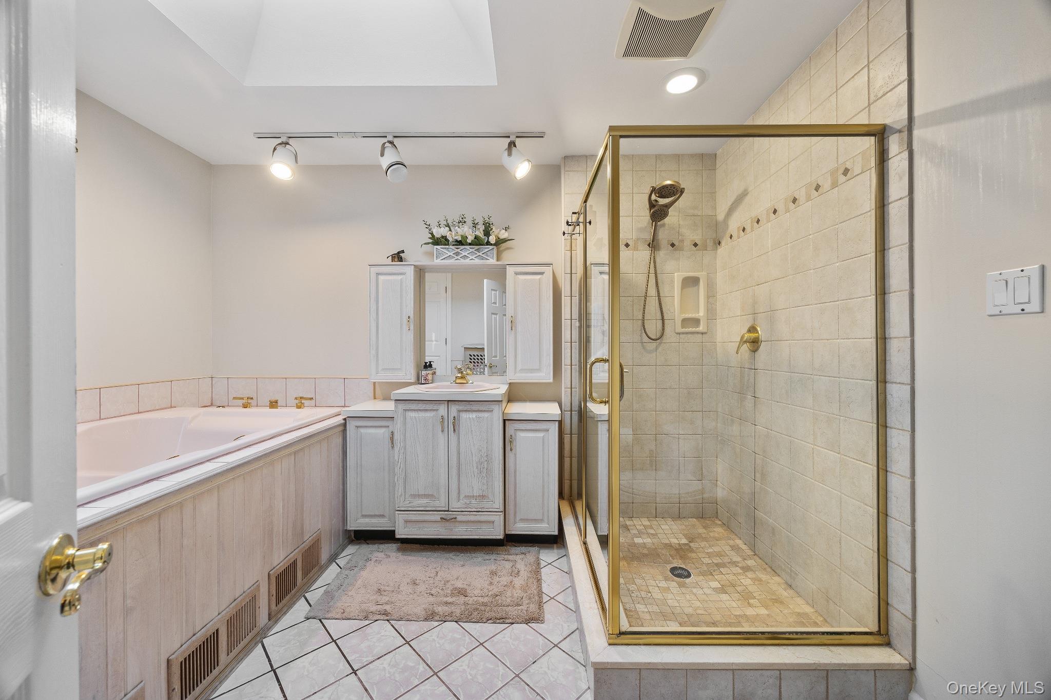 461 Wolf Hill Road Dix Hills, NY 11746 - Photo 20 of 37 a bathroom with a bathtub shower sink vanity and mirror