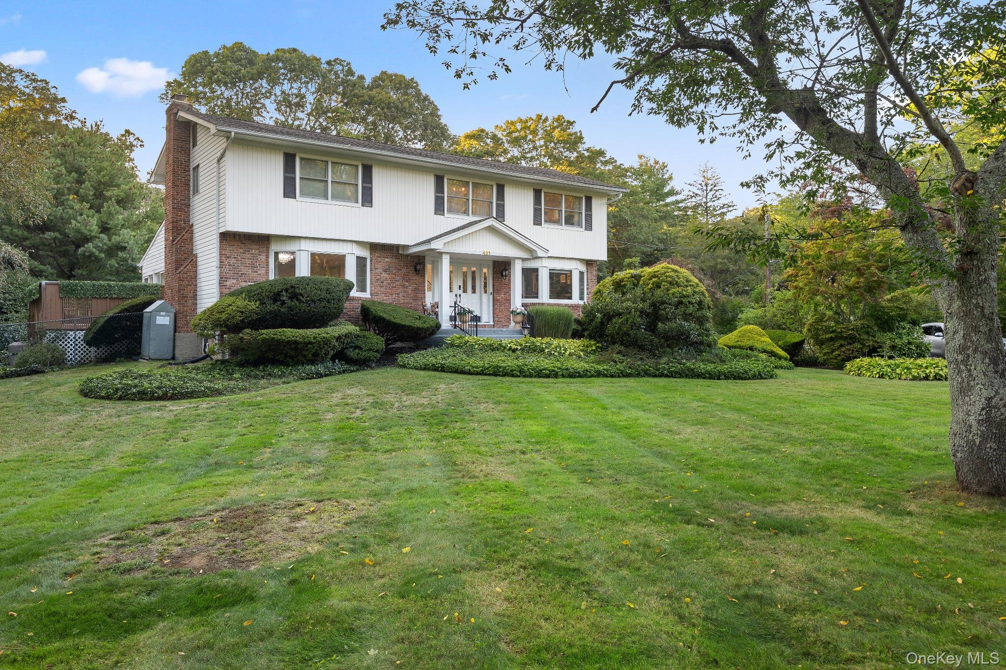 461 Wolf Hill Road Dix Hills, NY 11746 - Photo 2 of 37 a front view of a house with a garden