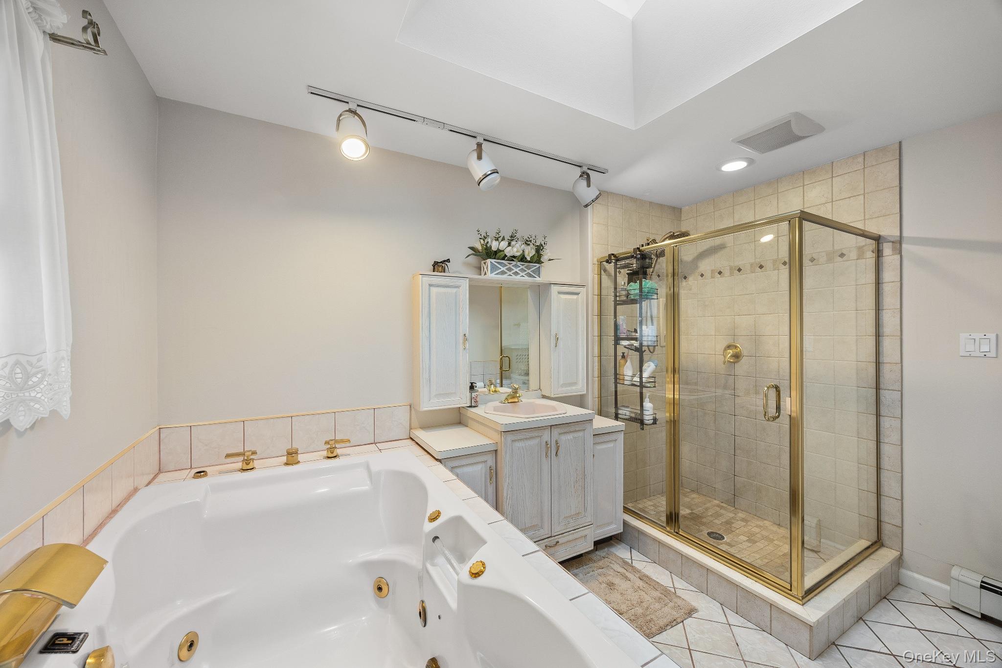461 Wolf Hill Road Dix Hills, NY 11746 - Photo 21 of 37 a bathroom with a tub sink shower and mirror