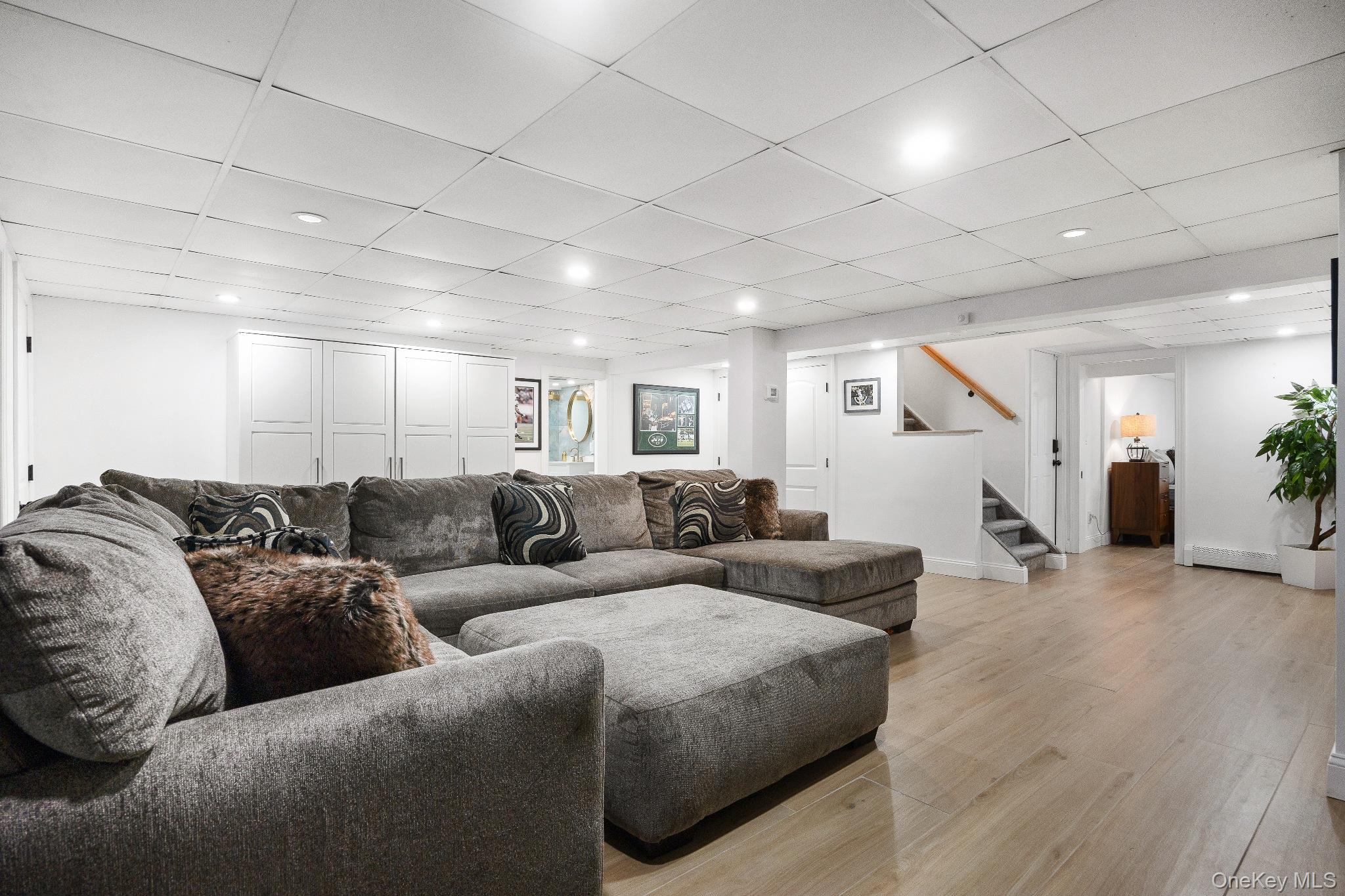 461 Wolf Hill Road Dix Hills, NY 11746 - Photo 27 of 37 a living room with furniture and wooden floor