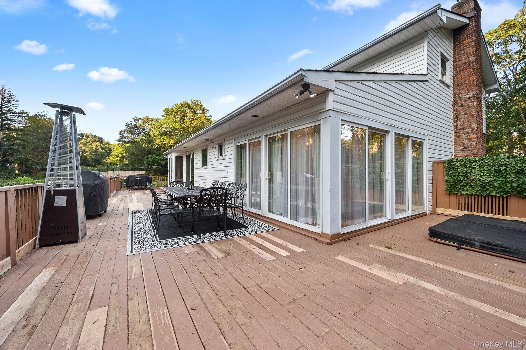 461 Wolf Hill Road Dix Hills, NY 11746 - Photo 31 of 37 a view of a terrace with couches and wooden floor