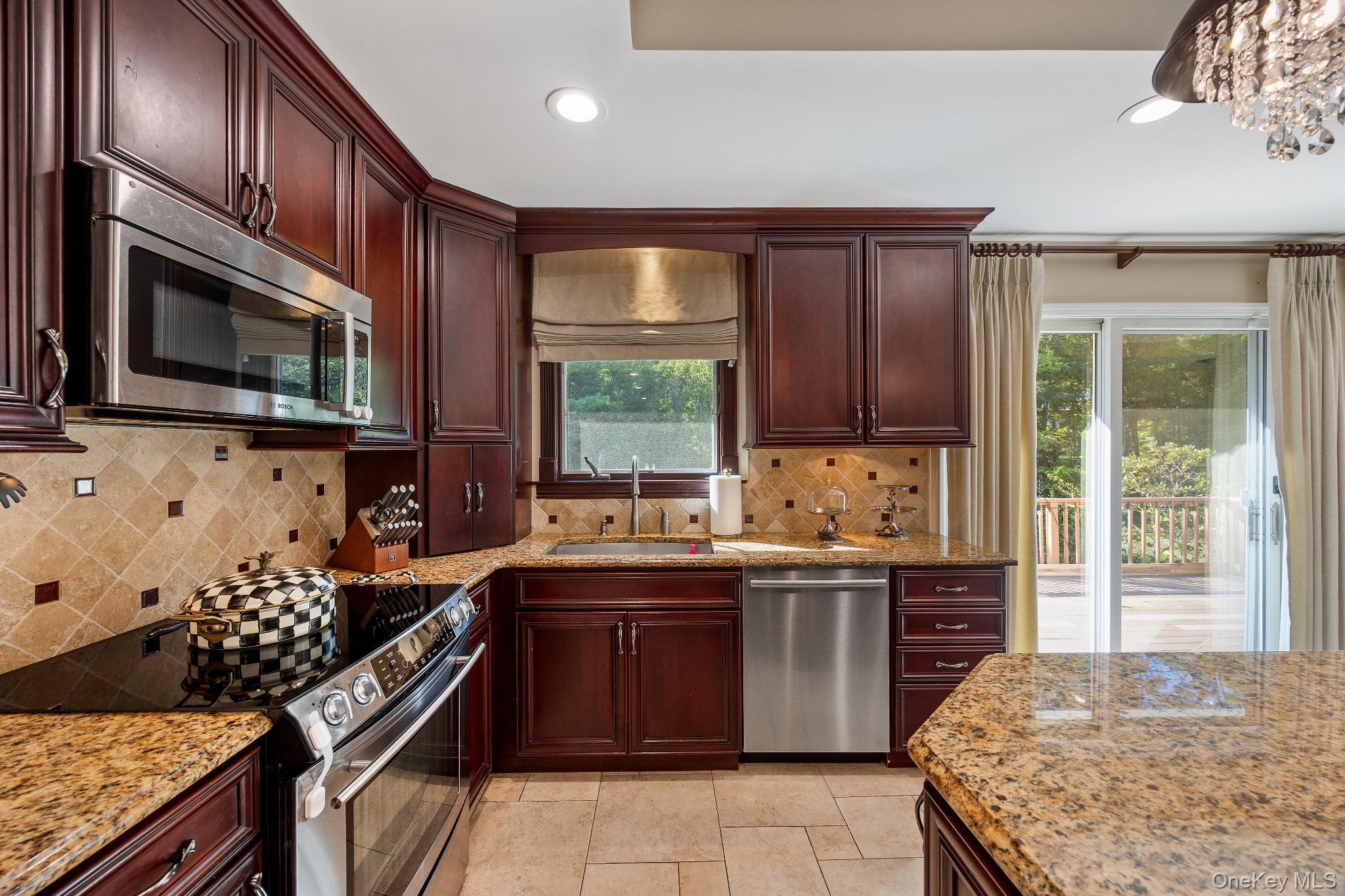 461 Wolf Hill Road Dix Hills, NY 11746 - Photo 10 of 37 a kitchen with stainless steel appliances granite countertop a stove a sink dishwasher and a microwave oven with cabinets