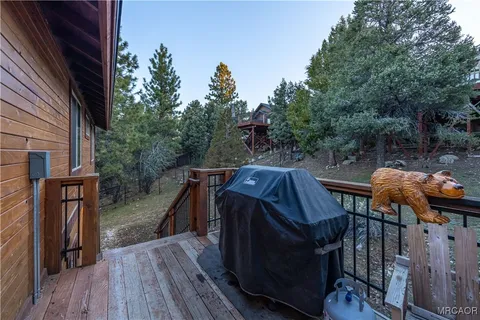 a roof deck with wooden floor and stairs