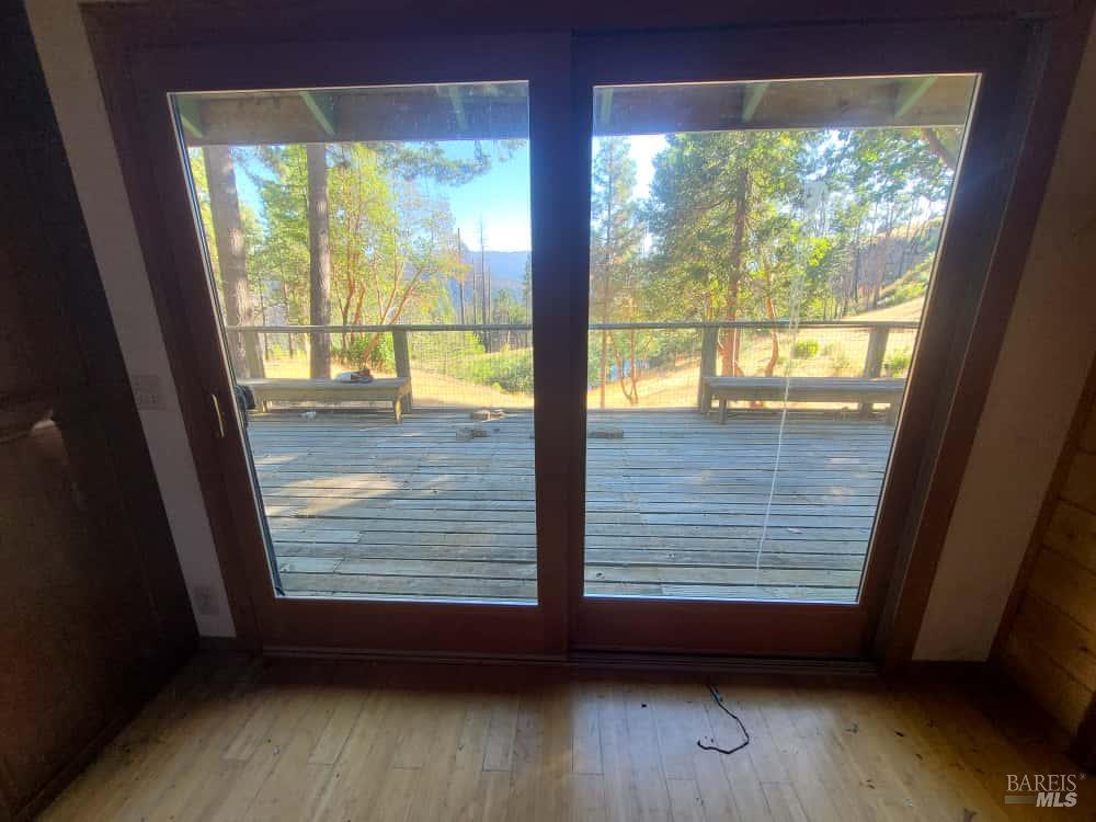 41390 Mendocino Pass Road Covelo, CA 95428 - Photo 11 of 44 a view of empty room with wooden floor and fan