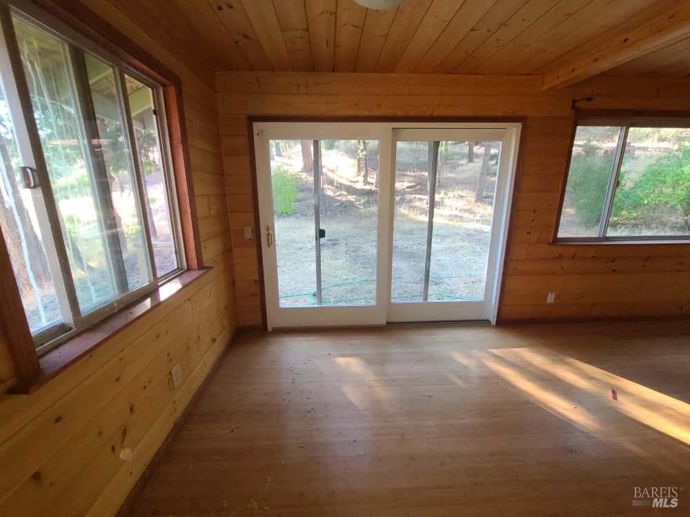 41390 Mendocino Pass Road Covelo, CA 95428 - Photo 19 of 44 a view of an empty room with wooden floor and a window