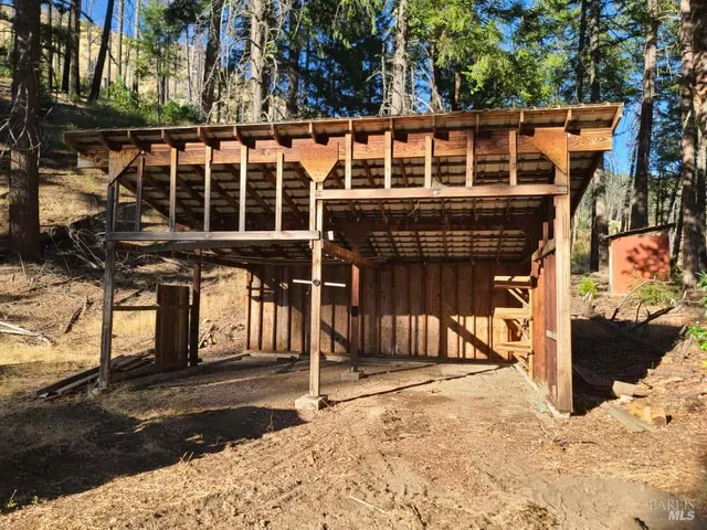 a view of a house with a wooden fence