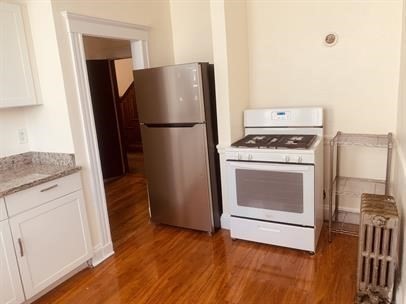 4 Hancock Street, Unit 2 Malden, MA 02148 - Photo 2 of 5 a kitchen with a stove top oven and refrigerator