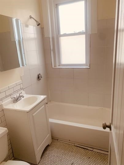 4 Hancock Street, Unit 2 Malden, MA 02148 - Photo 4 of 5 a bathroom with a sink a toilet and a bathtub