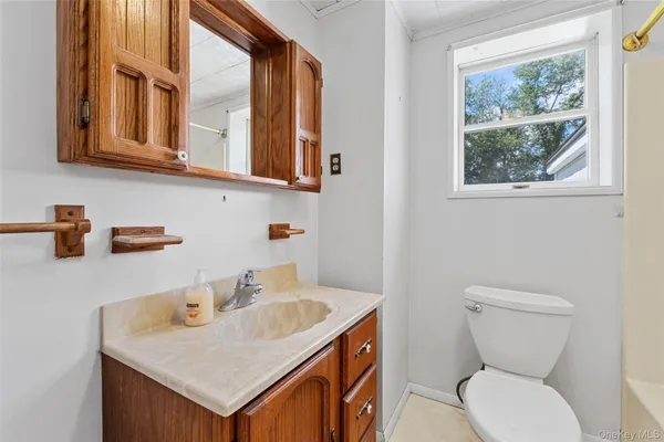 a bathroom with a toilet sink and mirror