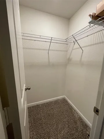 a view of an empty room with a kitchen