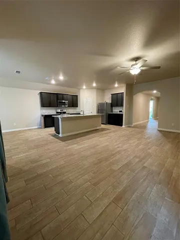 a large kitchen with stainless steel appliances kitchen island a large counter top and a sink