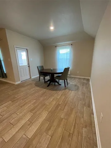 a living room with chairs and a table with wooden floor