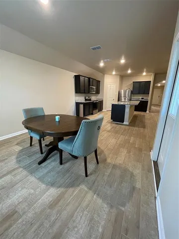 a kitchen with granite countertop cabinets stove and microwave