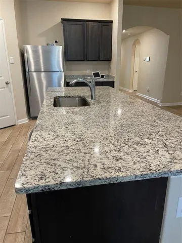 a kitchen with a sink and a mirror
