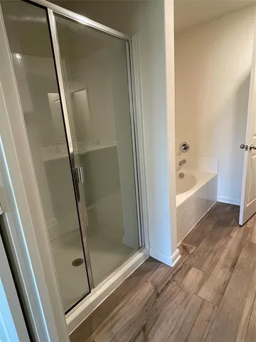a spacious bathroom with a double vanity sink and a mirror