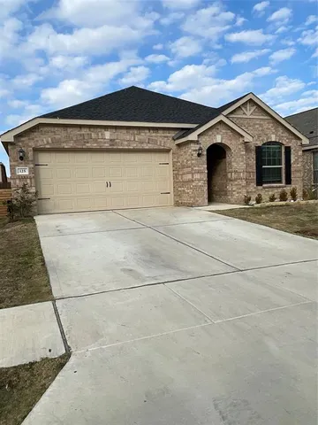 a front view of a house with garage
