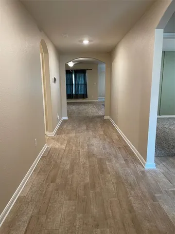 an entryway of an empty room and fire place