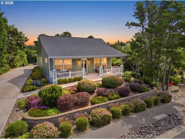 a front view of a house with a yard and outdoor seating