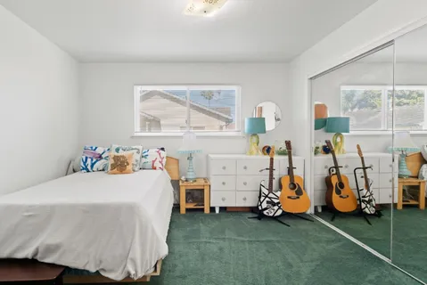 a bedroom with bed and a large window